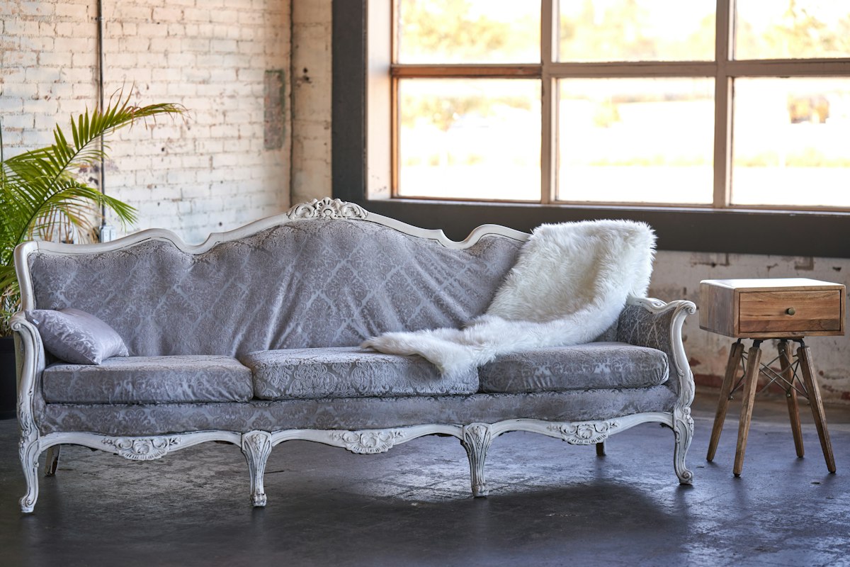 a couch with a blanket on it in a room