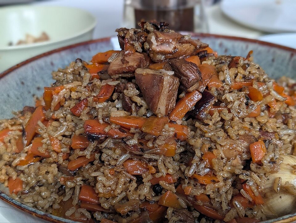 Plov with lamb and carrots in ceramic bowl
