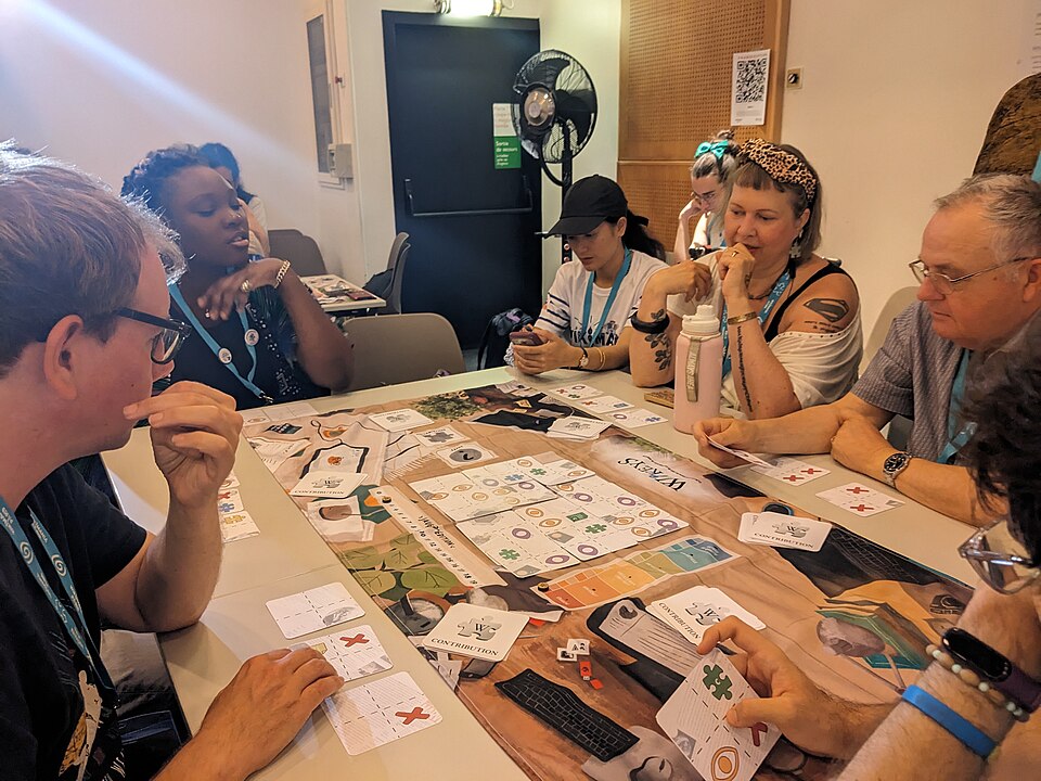 People playing board game during session 'Play Wikeys, the board game to discover Wikipedia' at Wikimania 2026, day 3