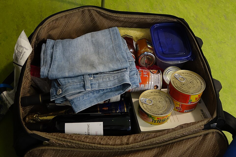 Suitcase and belongings of South Korean tourist in Paris