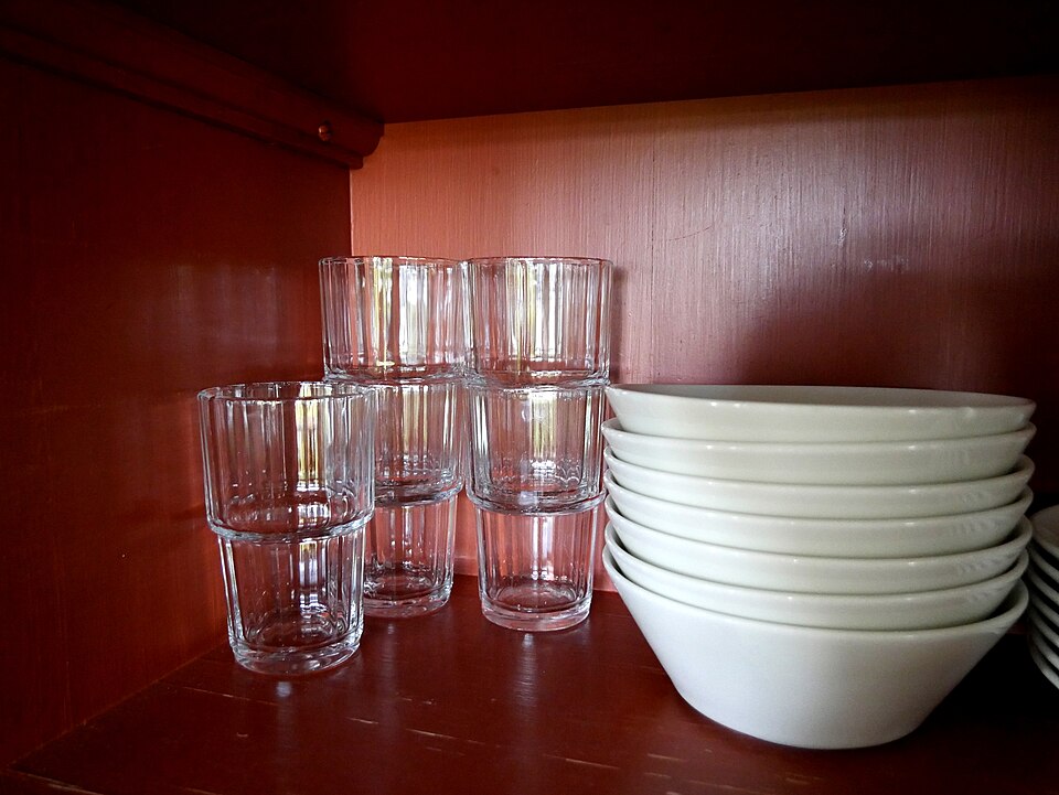Drinking glasses and plates in kitchen cupboard 20170903